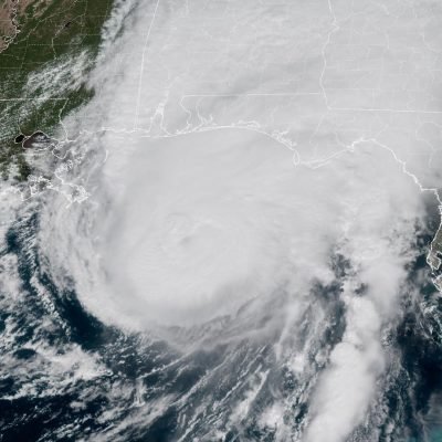 ‘The storm is here – buckle down’: Hurricane Isaias makes landfall in US